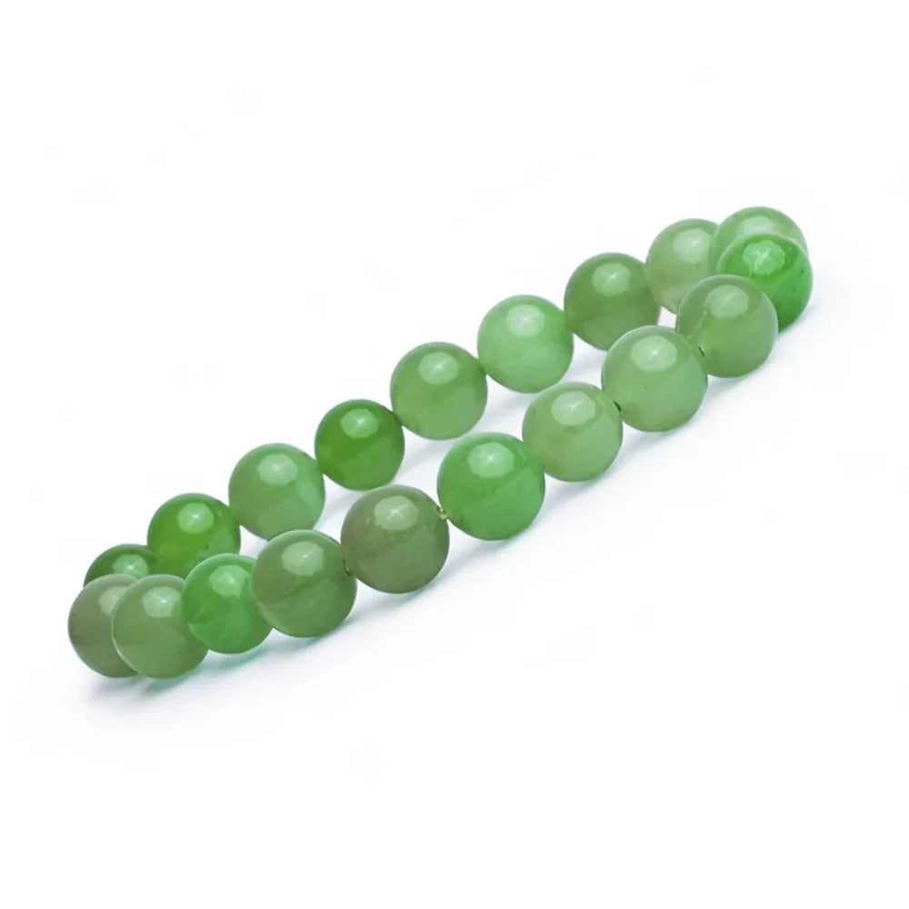 A strand of round, polished green beads arranged diagonally on a clean white background.